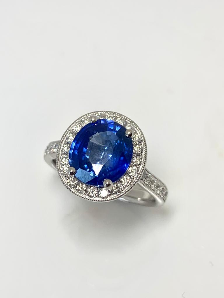 3.10CT OVAL ROYAL BLUE SRI LANKAN SAPPHIRE AND DIAMOND HALO RING