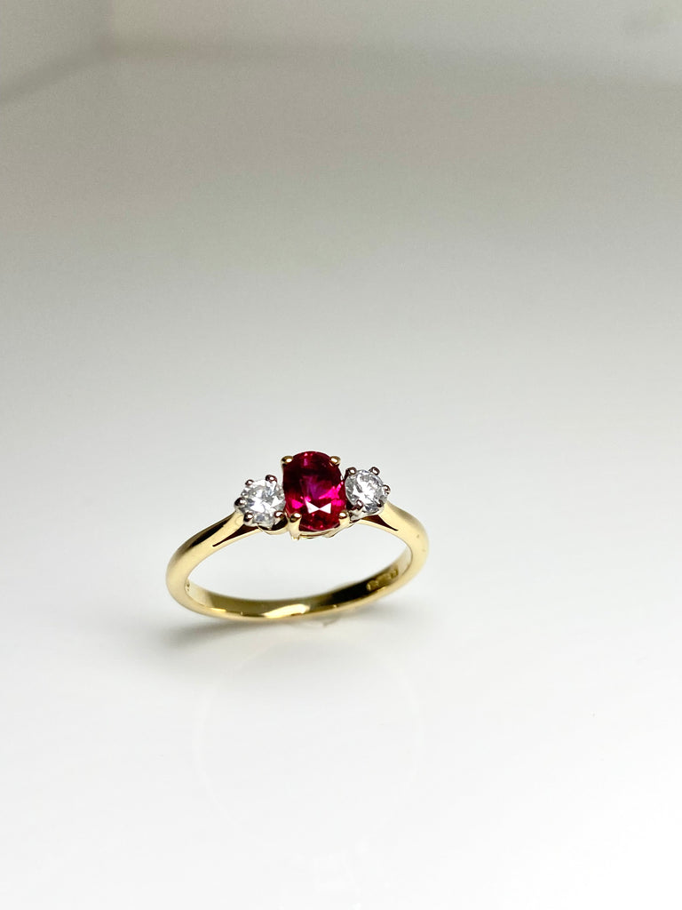 18CT GOLD OVAL 50PT RUBY AND 25PT DIAMOND TRILOGY RING