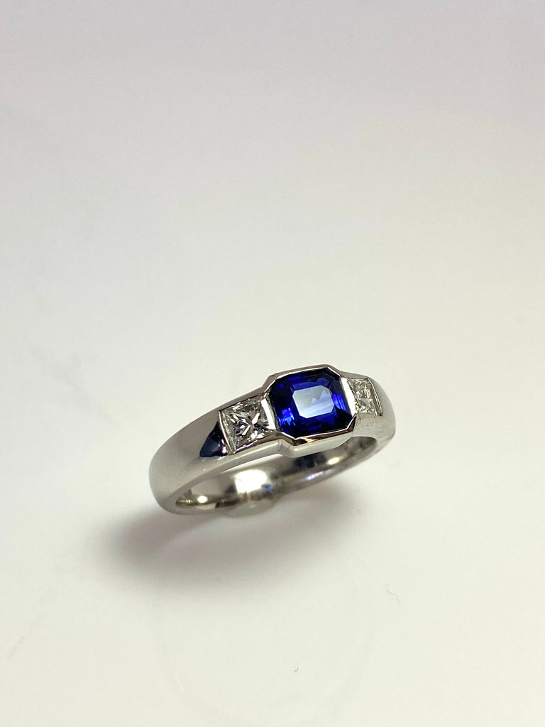 PLATINUM ROYAL BLUE SAPPHIRE AND DIAMOND FLUSH SET TRILOGY RING