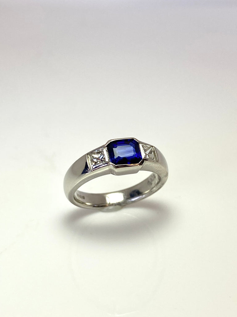PLATINUM ROYAL BLUE SAPPHIRE AND DIAMOND FLUSH SET TRILOGY RING