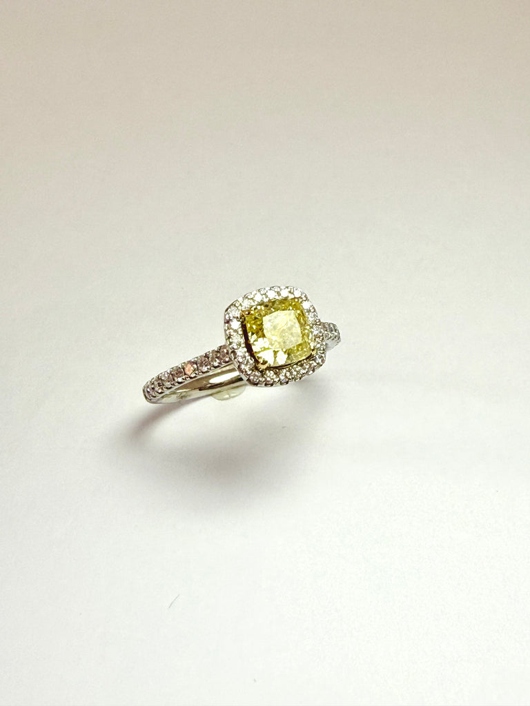 Ring with a yellow diamond and diamond-halo and shoulders 
