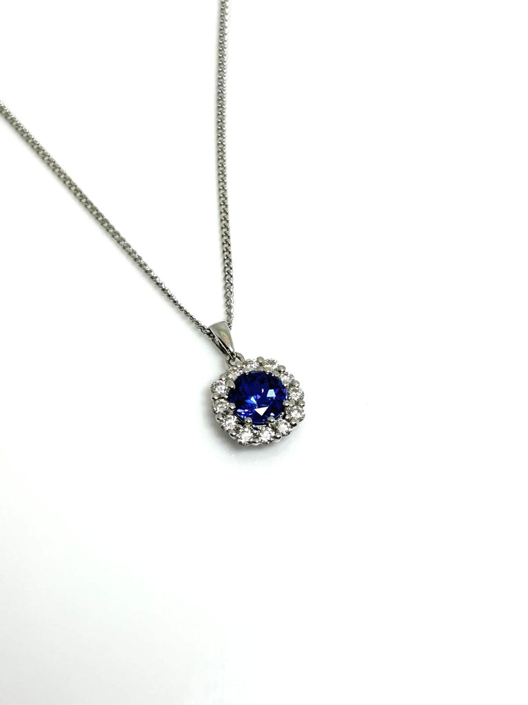 18CT TANZANITE AND DIAMOND HALO PENDANT